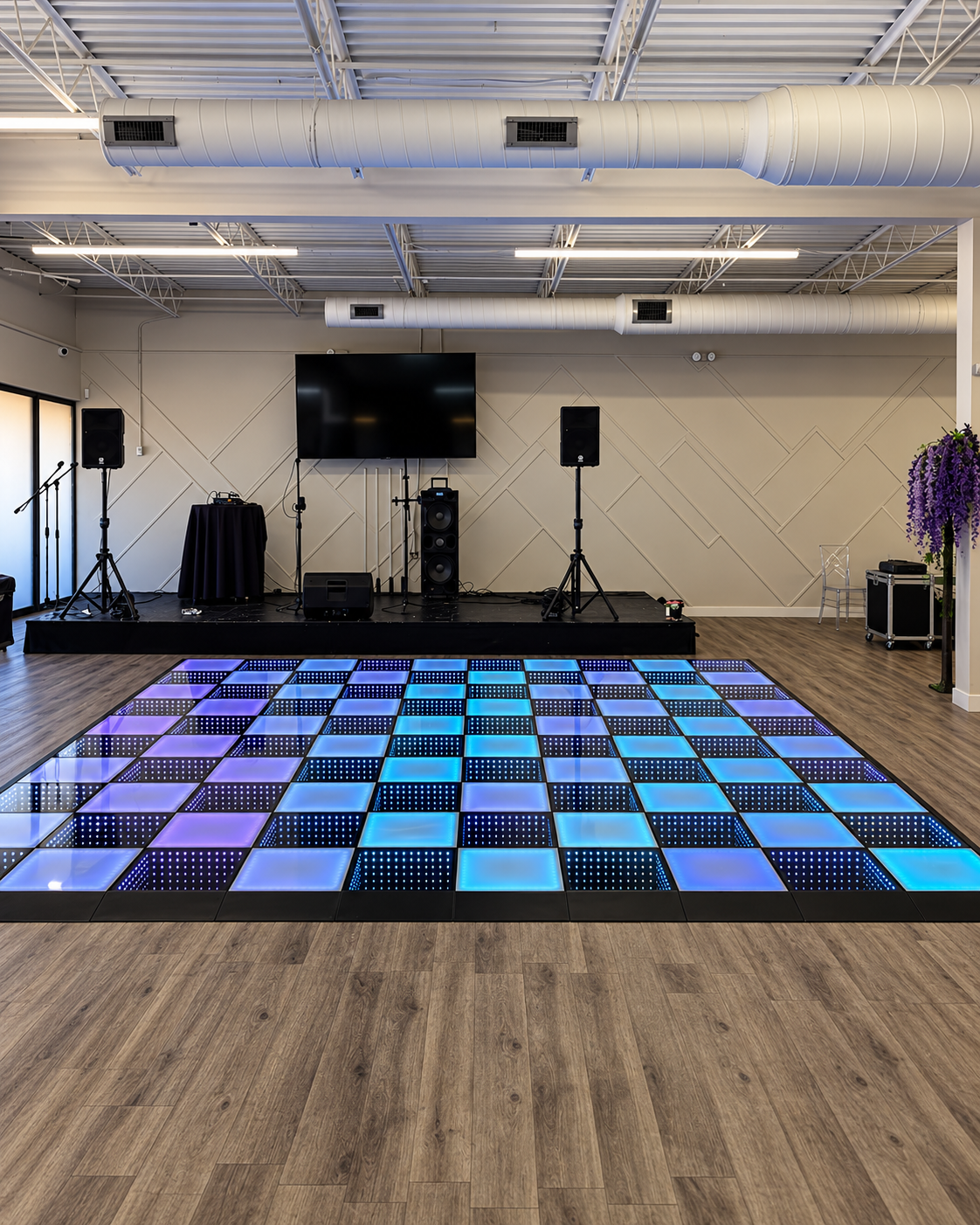 16 by 16 foot LED infinity dance floor with a stage in the background
