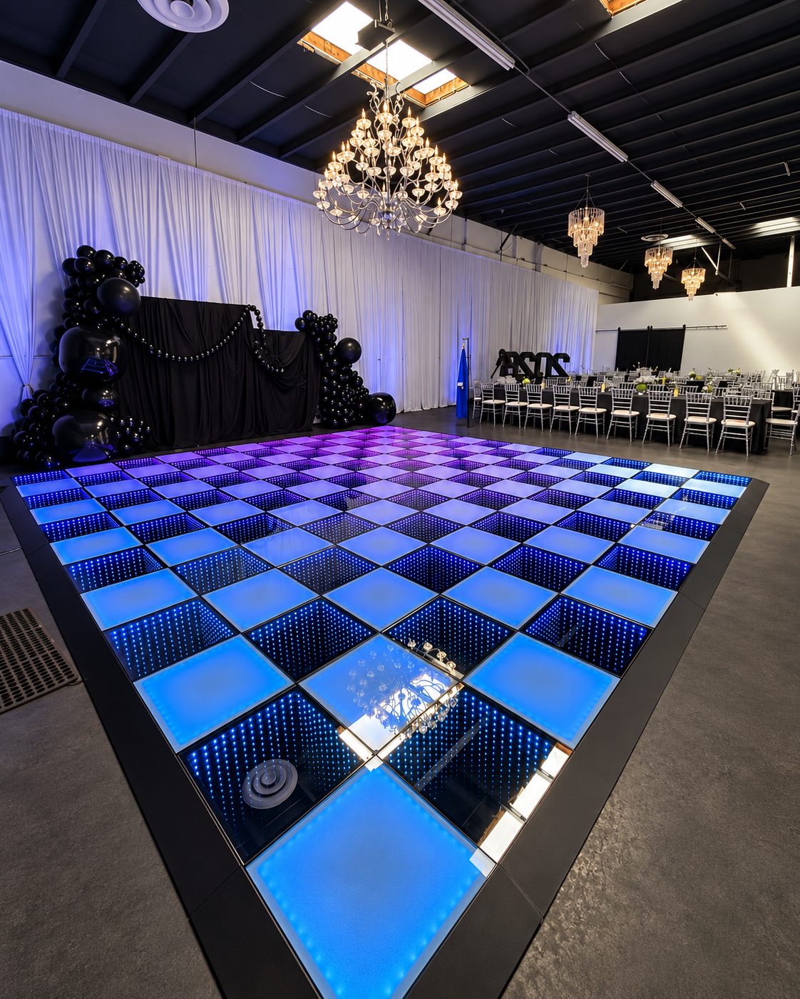 20 by 20 foot LED infinity dance floor beneath chandeliers at an event venue