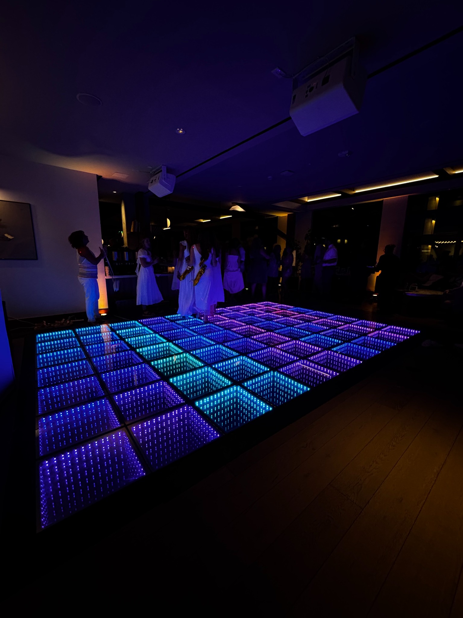 5280 Dance LLC infinity dance floor glowing blue and purple at an indoor celebration